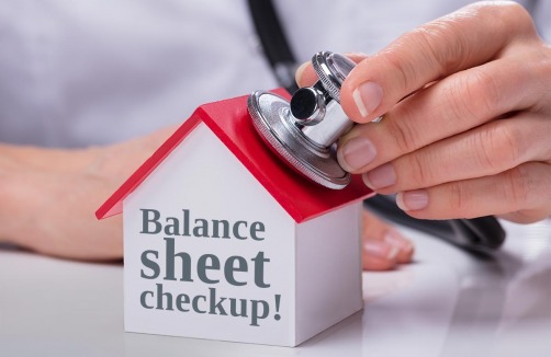 someone putting a stethoscope on top of a house