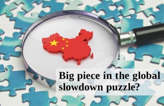 magnifying glass looking at red puzzle piece while surrounded by blue puzzle pieces