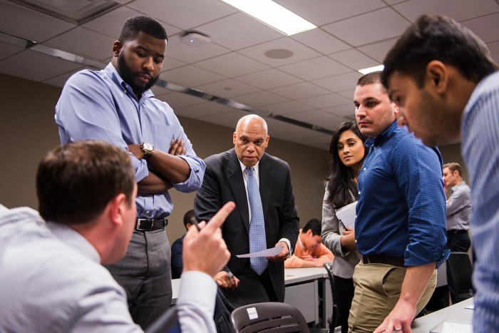 Students and faculty in a classroom having a discussion